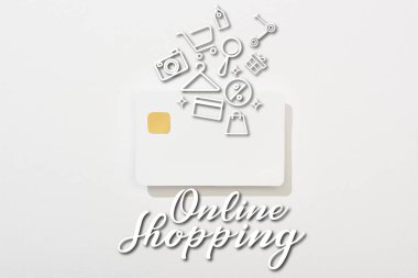 top view of empty credit card on white background with online shopping illustration