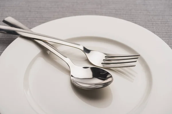 Close View Shiny Spoon Fork Plate Grey Surface — Stock Photo, Image