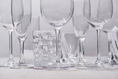 Empty glasses on white surface isolated on grey  clipart