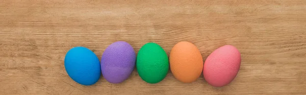 Top View Rainbow Painted Easter Eggs Wooden Table Panoramic Shot — 图库照片