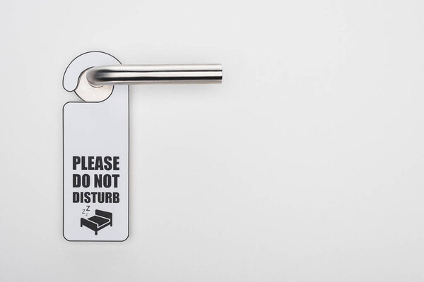 please do no disturb sign on handle on white background