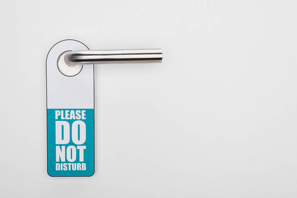 please do no disturb sign on handle on white background