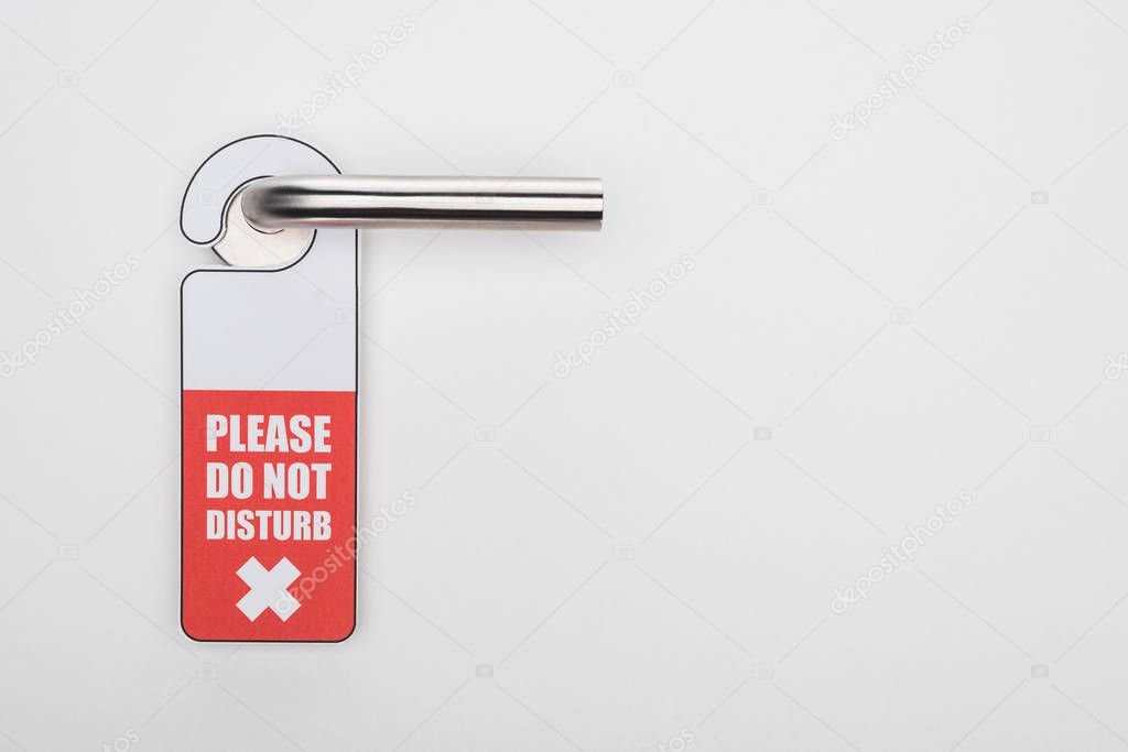 please do no disturb sign on handle on white background