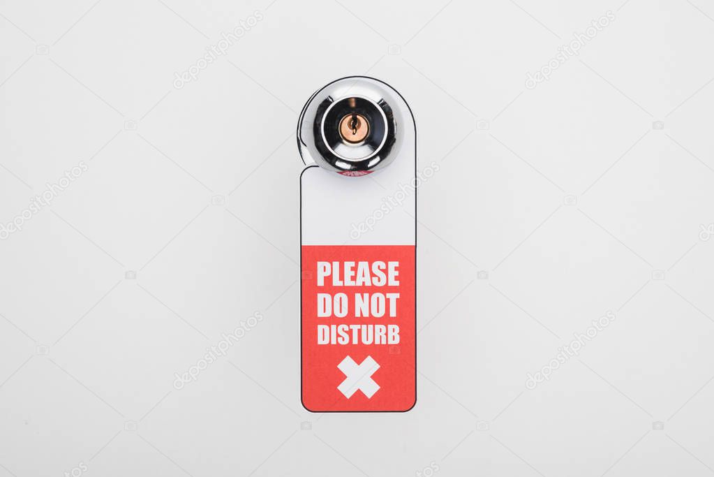 please do no disturb sign on handle with lock on white background