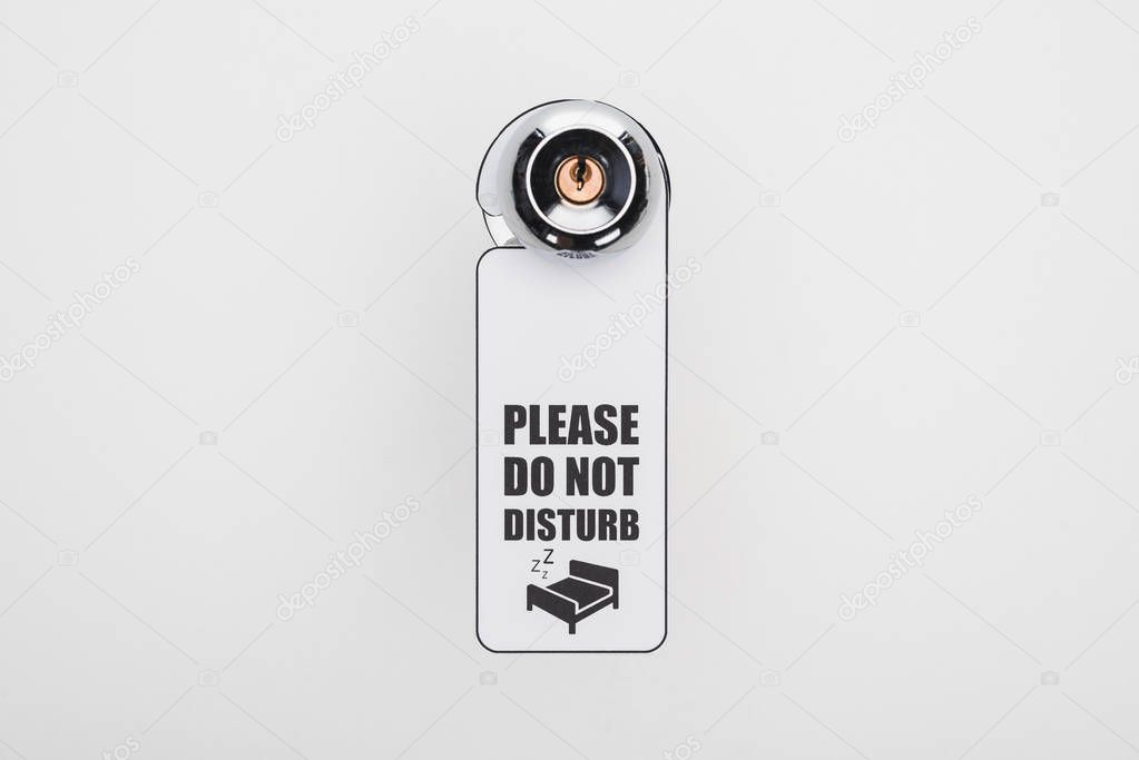 please do no disturb sign on handle with lock on white background