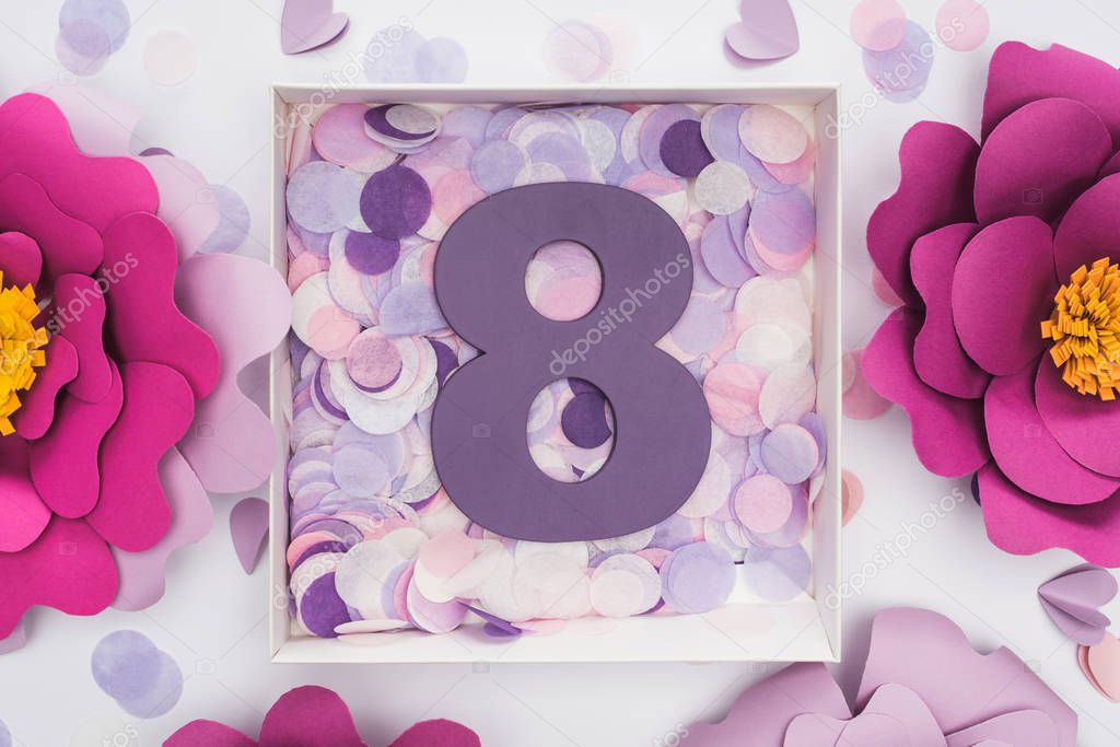 top view of paper flowers, confetti and number 8 in box isolated on white