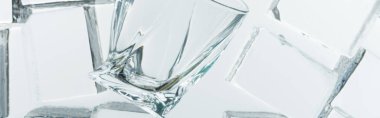 top view of transparent clear square ice cubes and empty glass on mirror, panoramic shot clipart