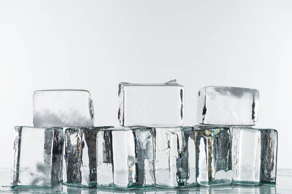 melting transparent clear square ice cubes isolated on white