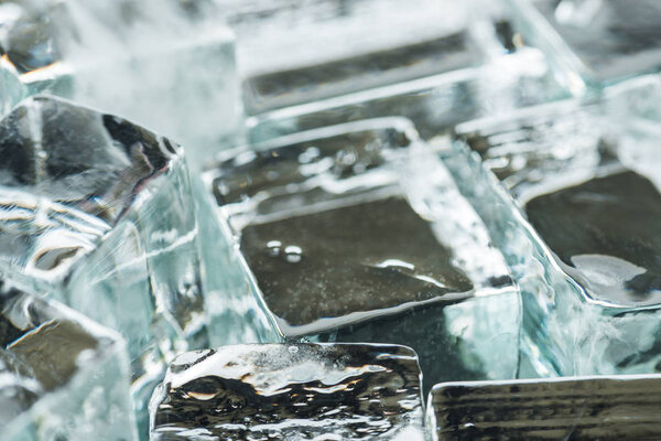 close up view of melting transparent clear square ice cubes