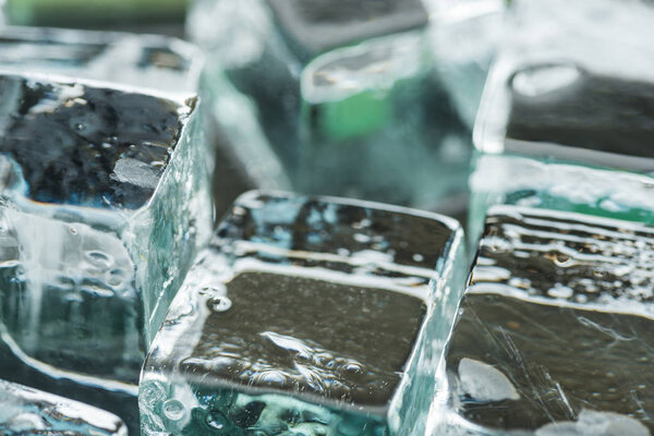 close up view of melting transparent clear square ice cubes