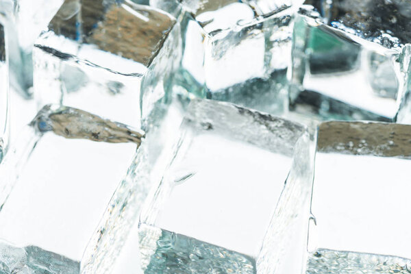 close up view of melting transparent clear square ice cubes