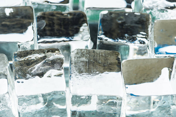 close up view of melting transparent clear square ice cubes