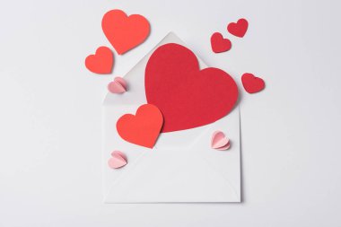 top view of red hearts and envelope on white background clipart