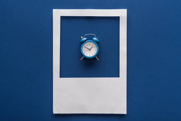 Top View Alarm Clock White Photo Frame Blue Background — Stockfoto