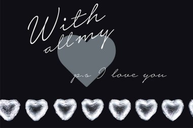 Top view of heart shaped candies isolated on black with all my and ps i love you lettering