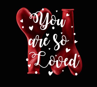 Top view of two red balloons in heart shape isolated on black with you are so loved lettering