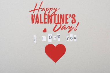 Top view of i love you lettering with paper heart and happy valentines day illustration isolated on grey