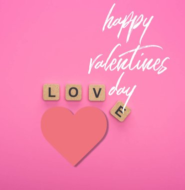 top view of love lettering on wooden cubes on pink background with happy valentines day illustration clipart