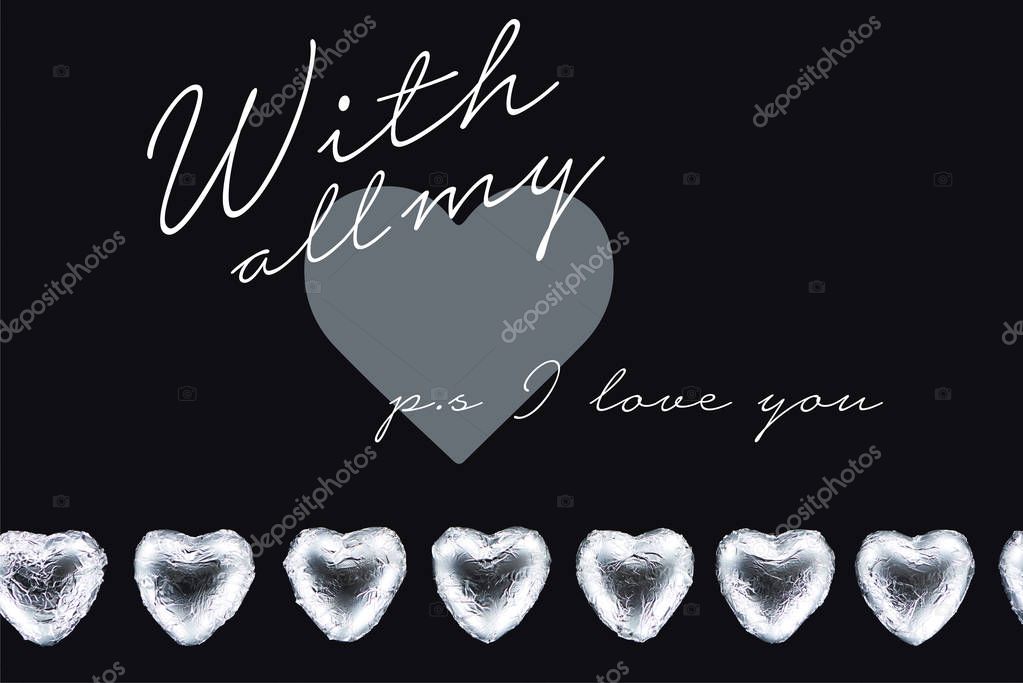 Top view of heart shaped candies isolated on black with all my and ps i love you lettering