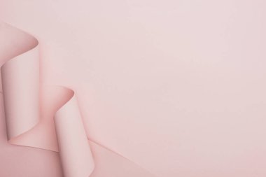 top view of pink paper swirl on pink background