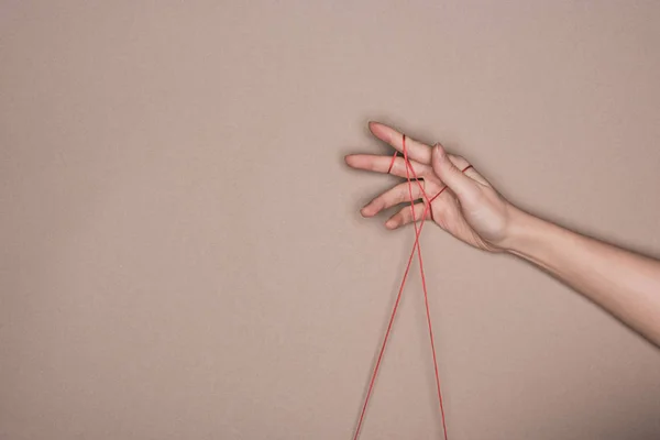 Bovenaanzicht Van Vrouwelijke Hand Met Rood Koord Beige Achtergrond — Stockfoto