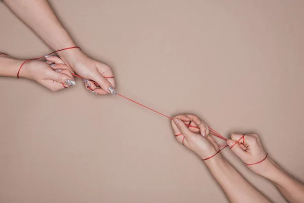 Top View Women Pulling Red String Beige Background — 스톡 사진
