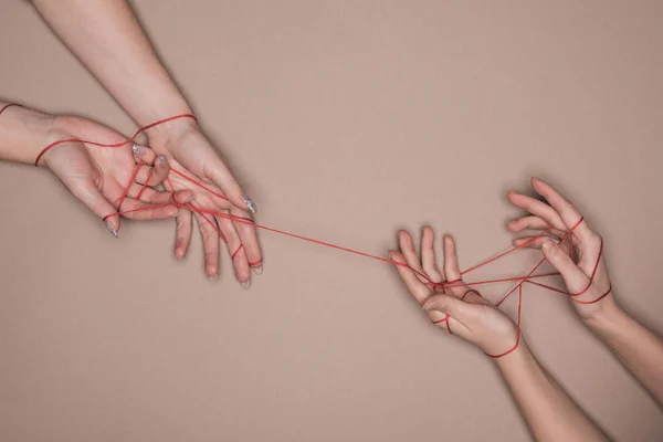 Top View Hands Women Wrapped Red Thread Beige Background — Stock Photo, Image