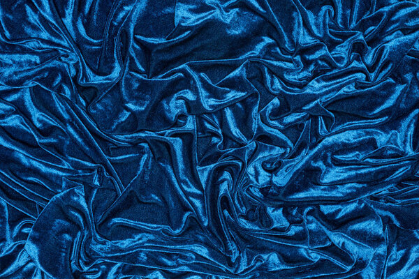 Top view of background with wavy blue cloth