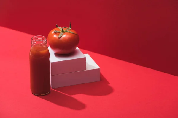 Fresh Vegetable Juice Glass Bottle Ripe Tomato Stand Red Background — 스톡 사진