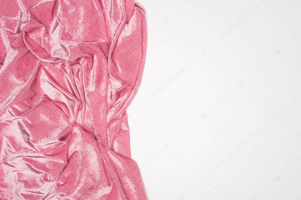 Top view of wavy pink velvet cloth isolated on white