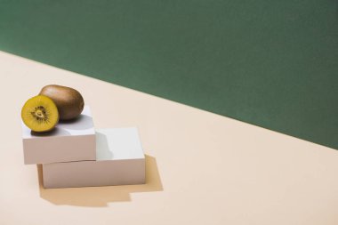 kiwi and and white cubes on green and white background