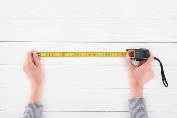 Top View Man Holding Industrial Measuring Tape White Wooden Surface — Stock Photo, Image