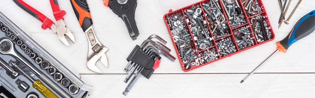 Top view of tools with tool boxes on white wooden surface, panoramic shot