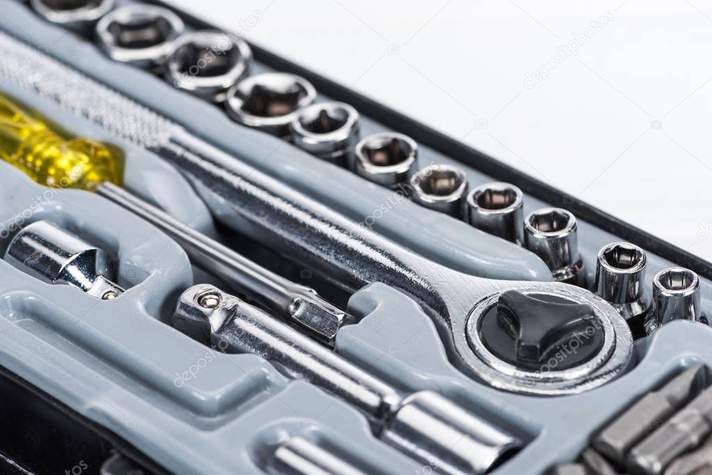 Close up view of toolbox with wrench and screwdriver isolated on white
