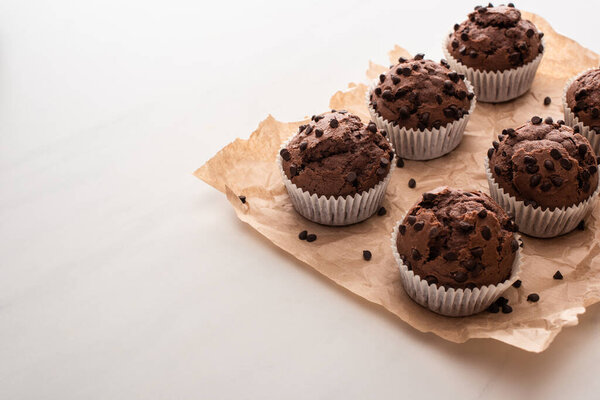 fresh chocolate muffins on parchment paper