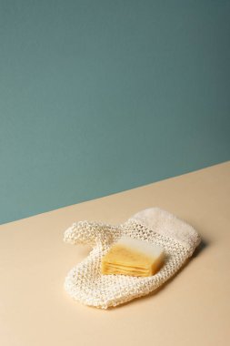 Bath glove with soap on beige and grey, zero waste concept  clipart
