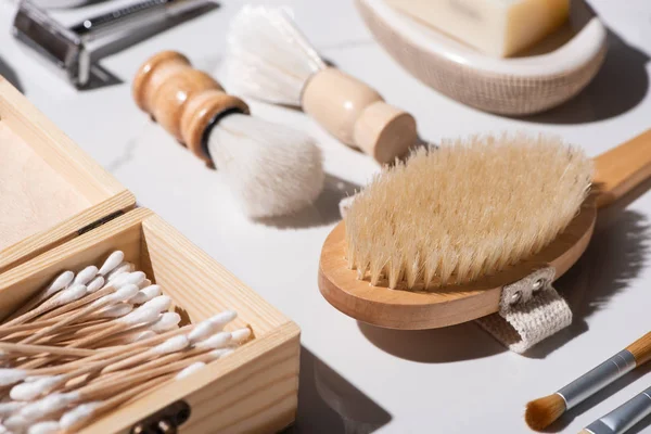 Selective focus of shaving brushes, box of ear sticks, Hair brush on white background, zero waste concept