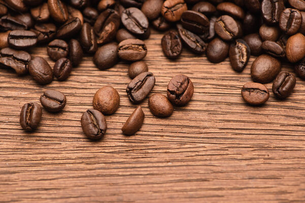 top view of fresh roasted coffee beans on wooden table