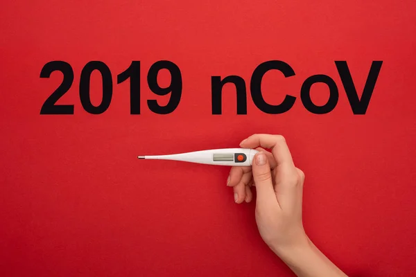 Top View Woman Holding Thermometer 2019 Ncov Lettering Red Background — Stock Photo, Image