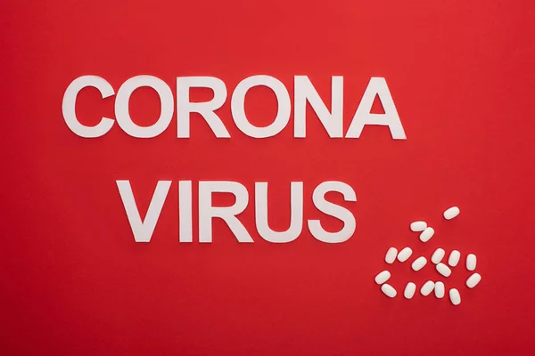 Κάτοψη Του Coronavirus Επιγραφή Χάπια Στην Κόκκινη Επιφάνεια — Φωτογραφία Αρχείου
