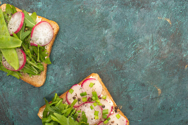 top view of organic radish sandwiches on green stone table