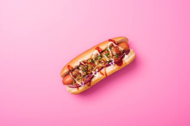top view of one tasty hot dog on pink clipart