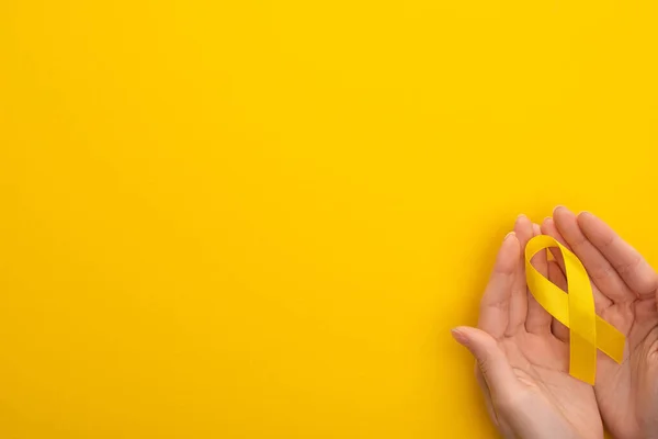 Cropped View Female Hands Yellow Awareness Ribbon Colorful Background International — Stock Photo, Image