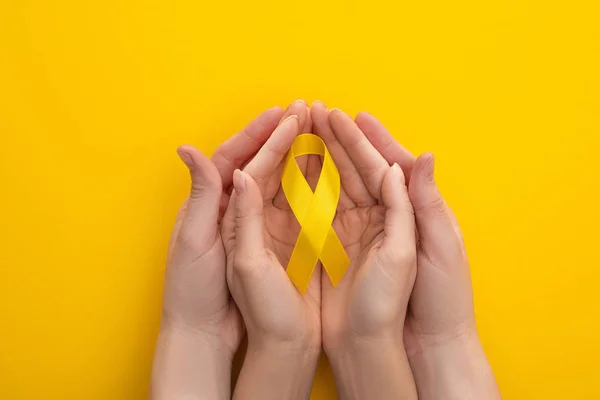 Cropped View Male Female Hands Yellow Ribbon Colorful Background International — Stock Photo, Image