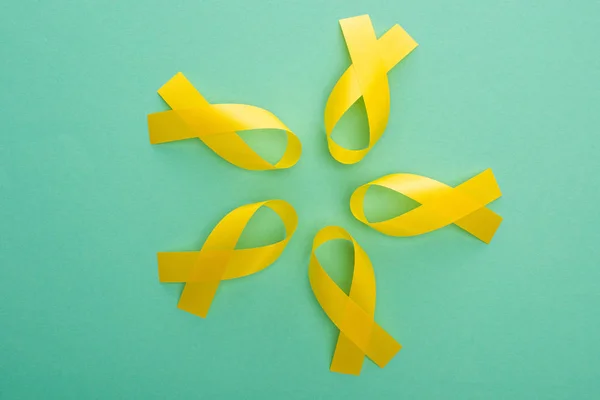 Top View Yellow Awareness Ribbons Turquoise Background International Childhood Cancer — Stock Photo, Image