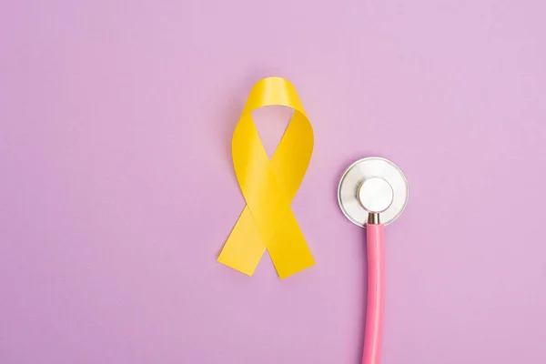 Top View Yellow Ribbon Stethoscope Violet Background International Childhood Cancer — Stock Photo, Image