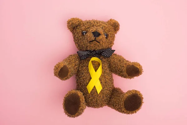 Top View Yellow Awareness Ribbon Teddy Bear Bow Pink Background — Stock Photo, Image