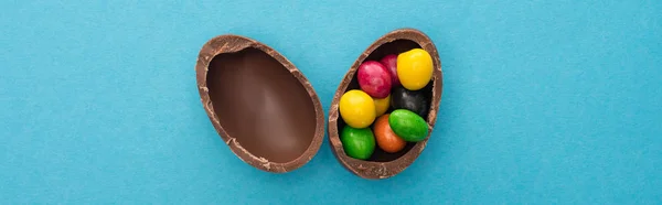 Top View Chocolate Easter Egg Halves Colorful Sweets Blue Background — Stock Photo, Image