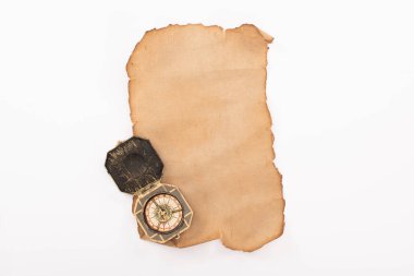 top view of vintage compass on aged empty paper isolated on white clipart