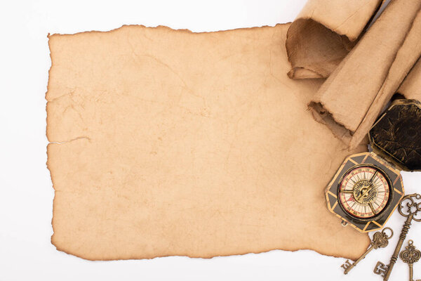 top view of vintage blank and rolled paper, keys and compass isolated on white